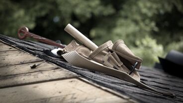 Pile of construction tools laying on a roof